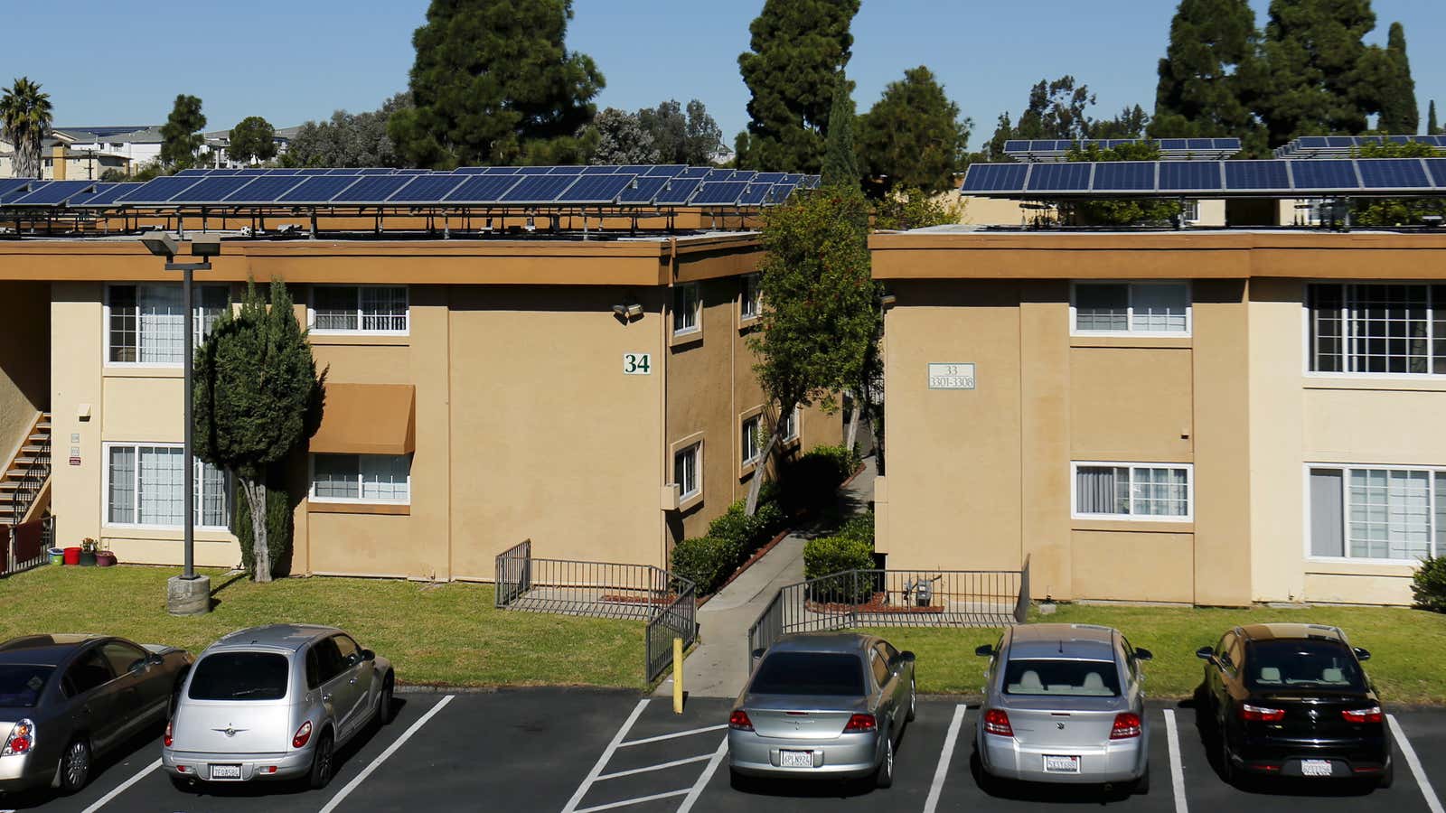 Solar panels are shown on top of a Multifamily Affordable Solar Housing-funded (MASH) housing complex in National City, California.