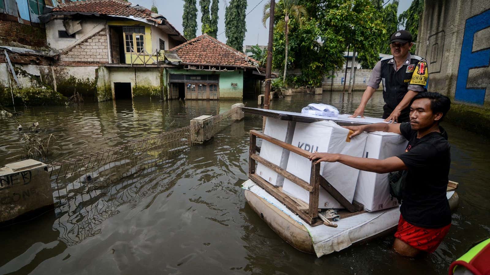 Officials transport election materials by raft in a flooded area of Indonesia’s Java island.