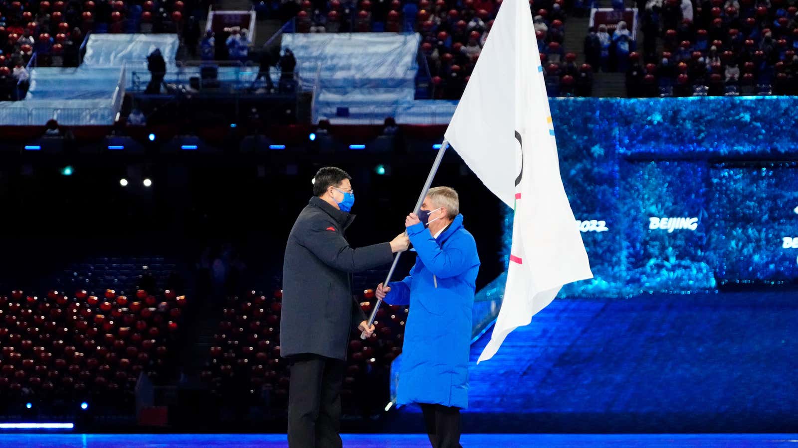 Mayor of Beijing Chen Jining hands IOC president Thomas Bach the Olympic flag during the closing ceremony.