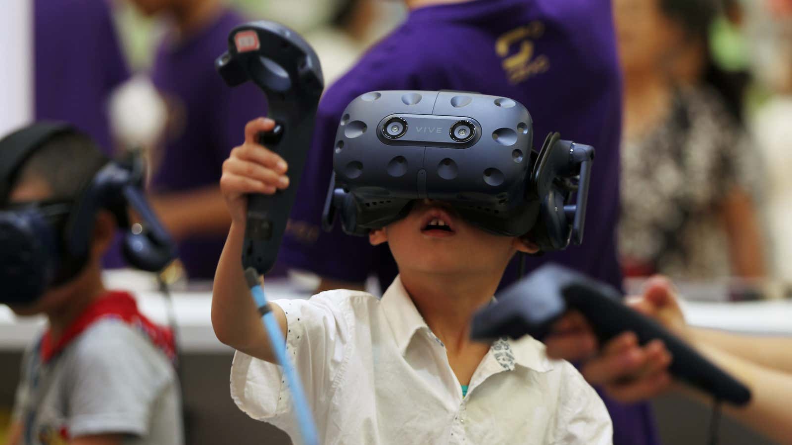 A child uses HTC’s Vive virtual reality headset.