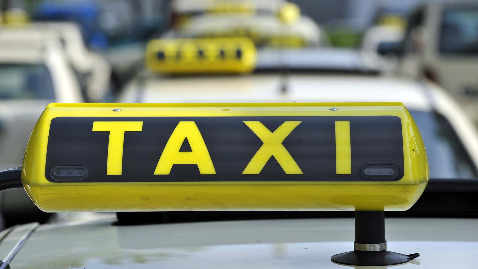 FILE – In this June 15, 2009 file photo taxi cabs are seen at Tegel Airport in Berlin. A court has issued an injunction barring…