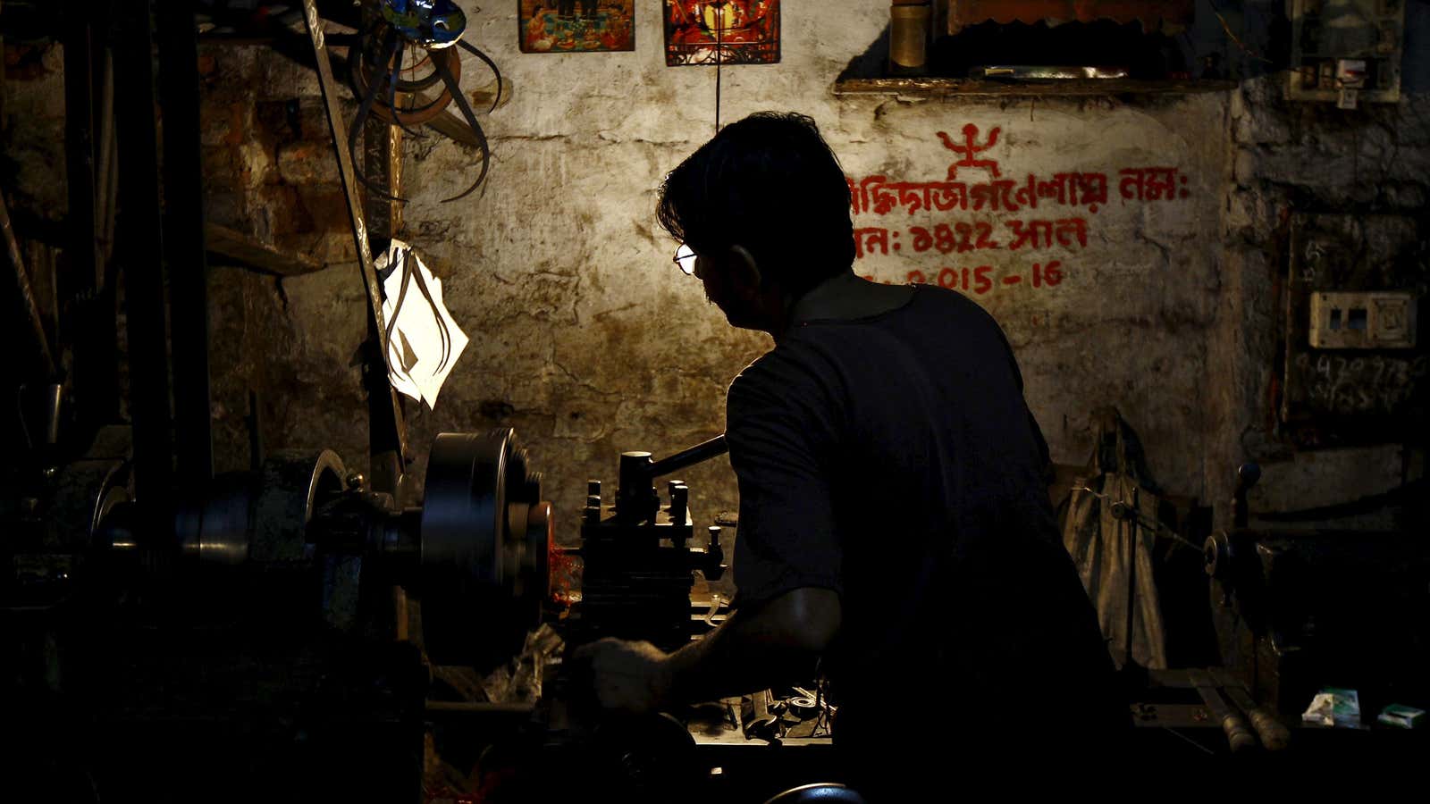 A worker operates a lathe machine as he makes car parts inside a small scale manufacturing unit in Kolkata, India, October 1, 2015. Indian manufacturing…