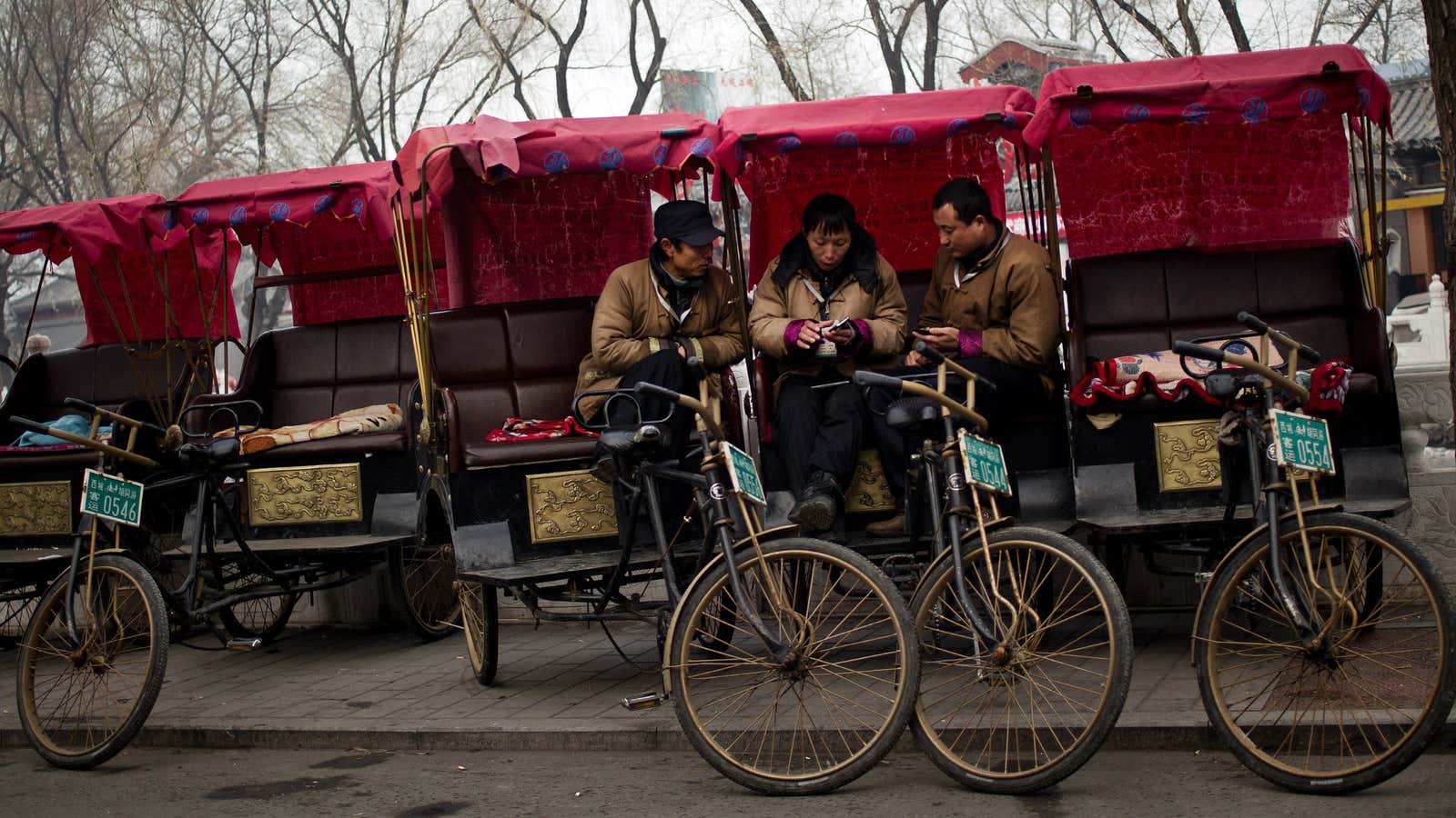 Drivers play with their mobile phones in Beijing.