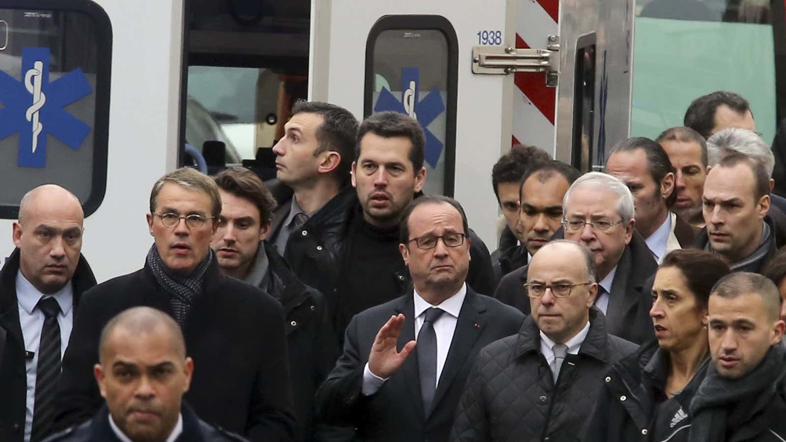 French President François Hollande, center, arriving outside Charlie Hebdo’s offices.