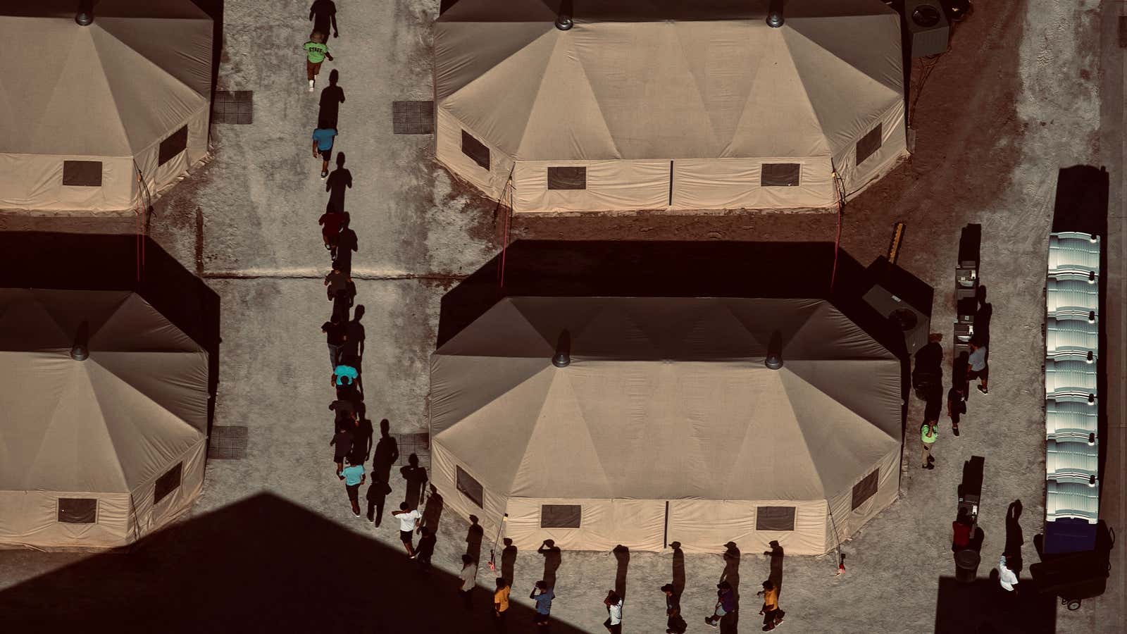 Migrant children walk single file at a detention facility in Texas.