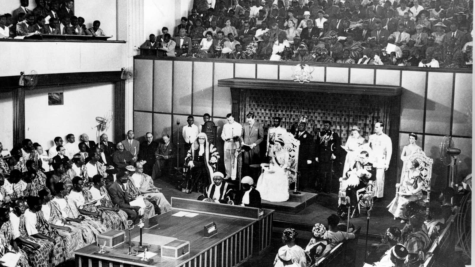 The Duchess of Kent, seated center on dais, reads a message from the Queen of England in the Parliament House at Accra, Ghana, on March 6, 1957, independence day.
