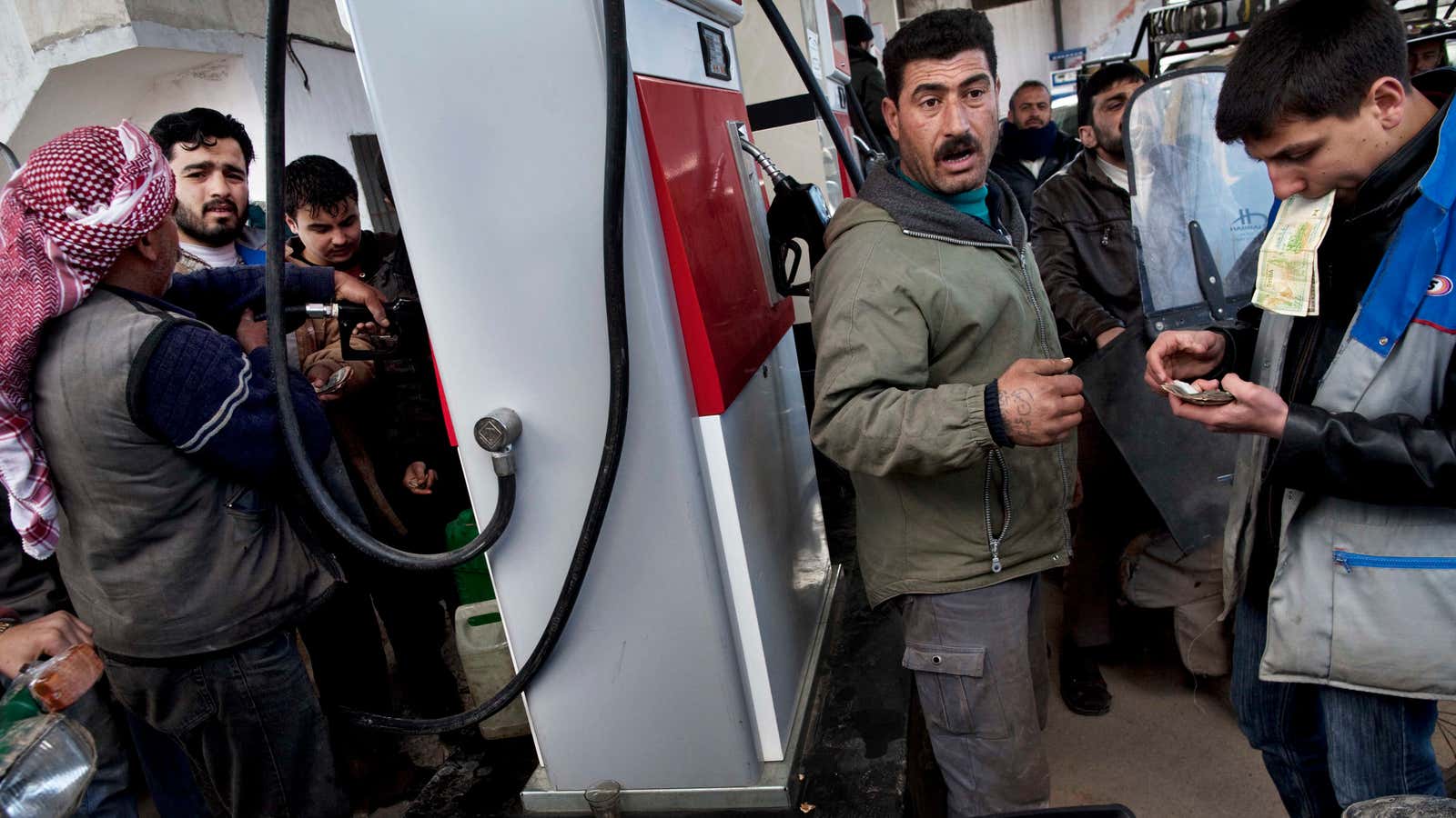 Syrians trying to buy gas amidst fuel shortages.