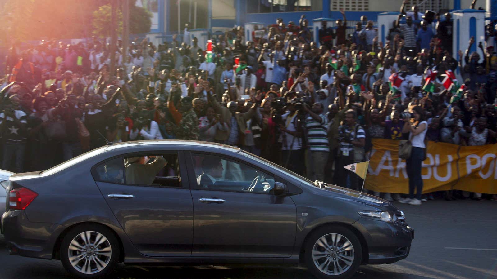 Pope rides into Nairobi in a humble Honda.