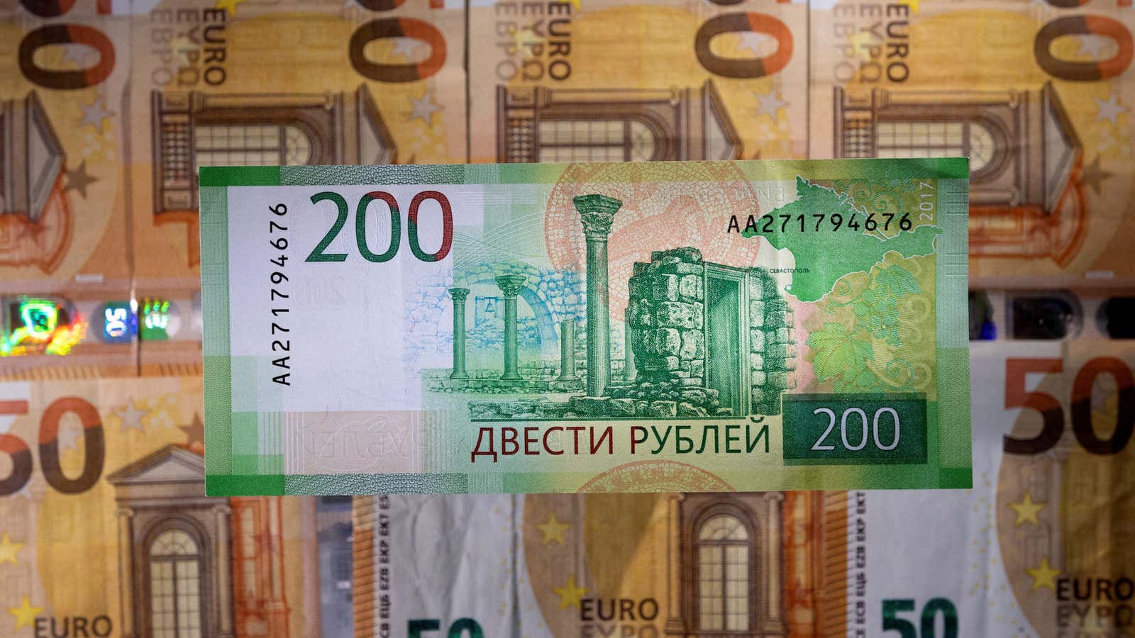 A Russian rouble banknote is placed on euro banknotes in this illustration taken March 1, 2022. REUTERS/Dado Ruvic/Illustration