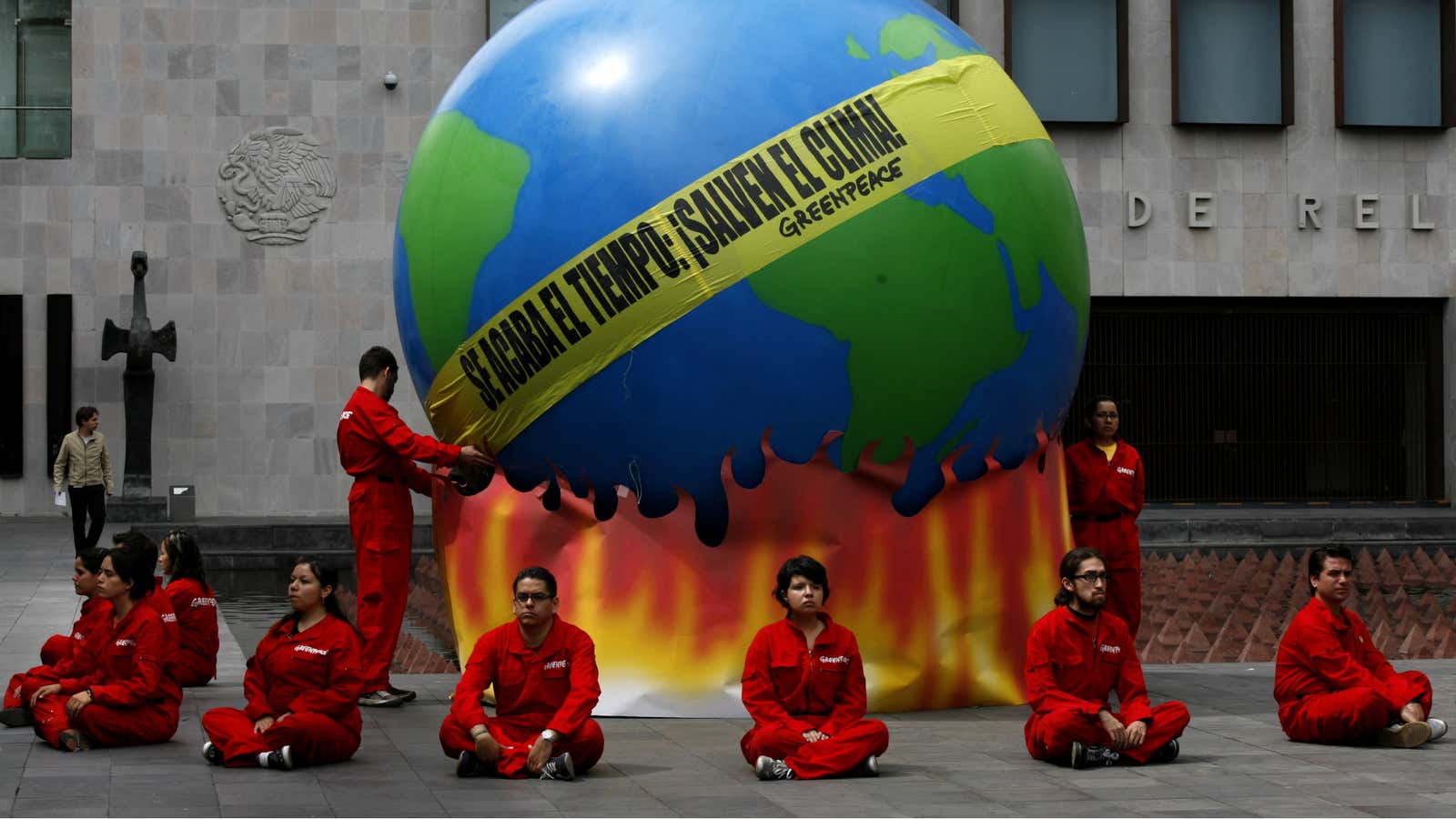 Greenpeace activists stage a protest with an earth-shaped balloon in front of Mexico Secretary of Foreign Relations in Mexico City, Thursday Aug. 27, 2009. The…
