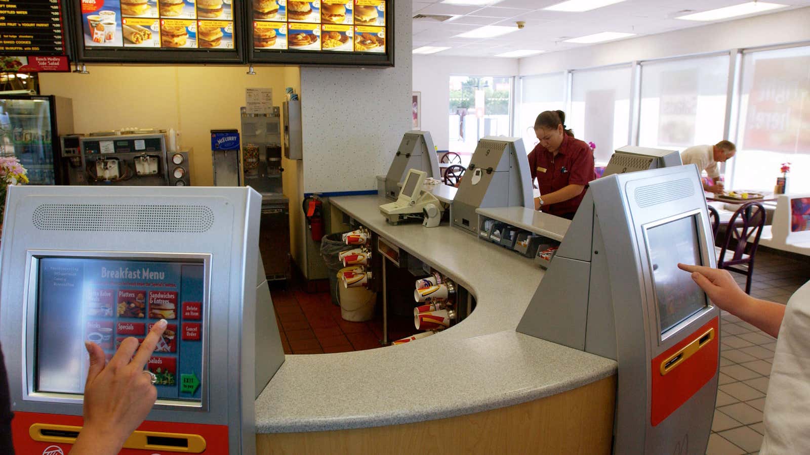 Customers at McDonald’s place breakfast orders through kiosk systems introduced in 2003.