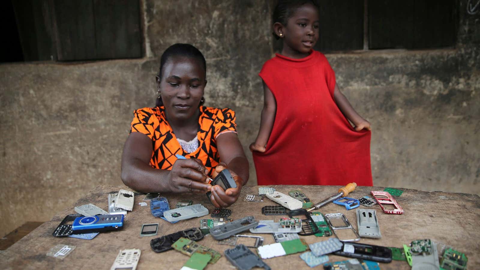 A woman repairs phones in southwest Nigeria