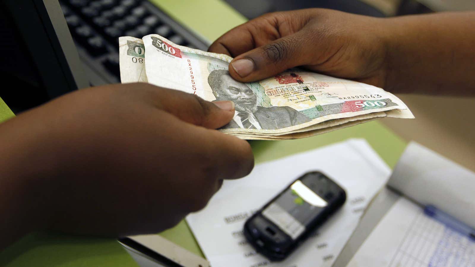 A customer conducts a mobile money transfer, known as M-Pesa.