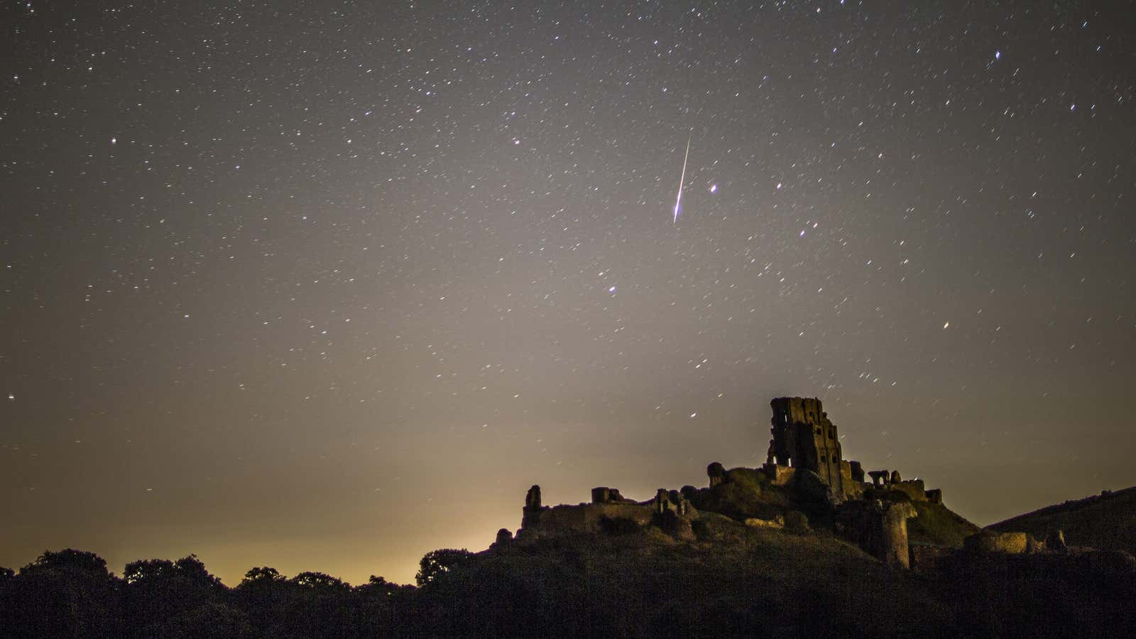 A meteor flashes across the night sky on Aug. 12, Corfe Castle, UK.