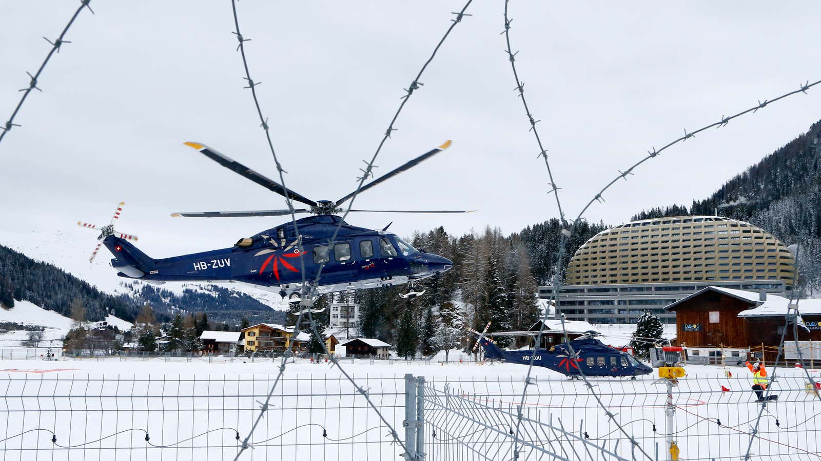 A participant arrives by private helicopter for the World Economic Forum in Davos.