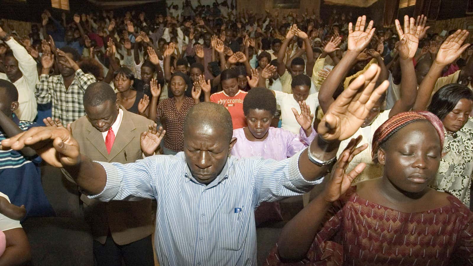 Worshipers in prayer at a Pentecostal church in Kampala,