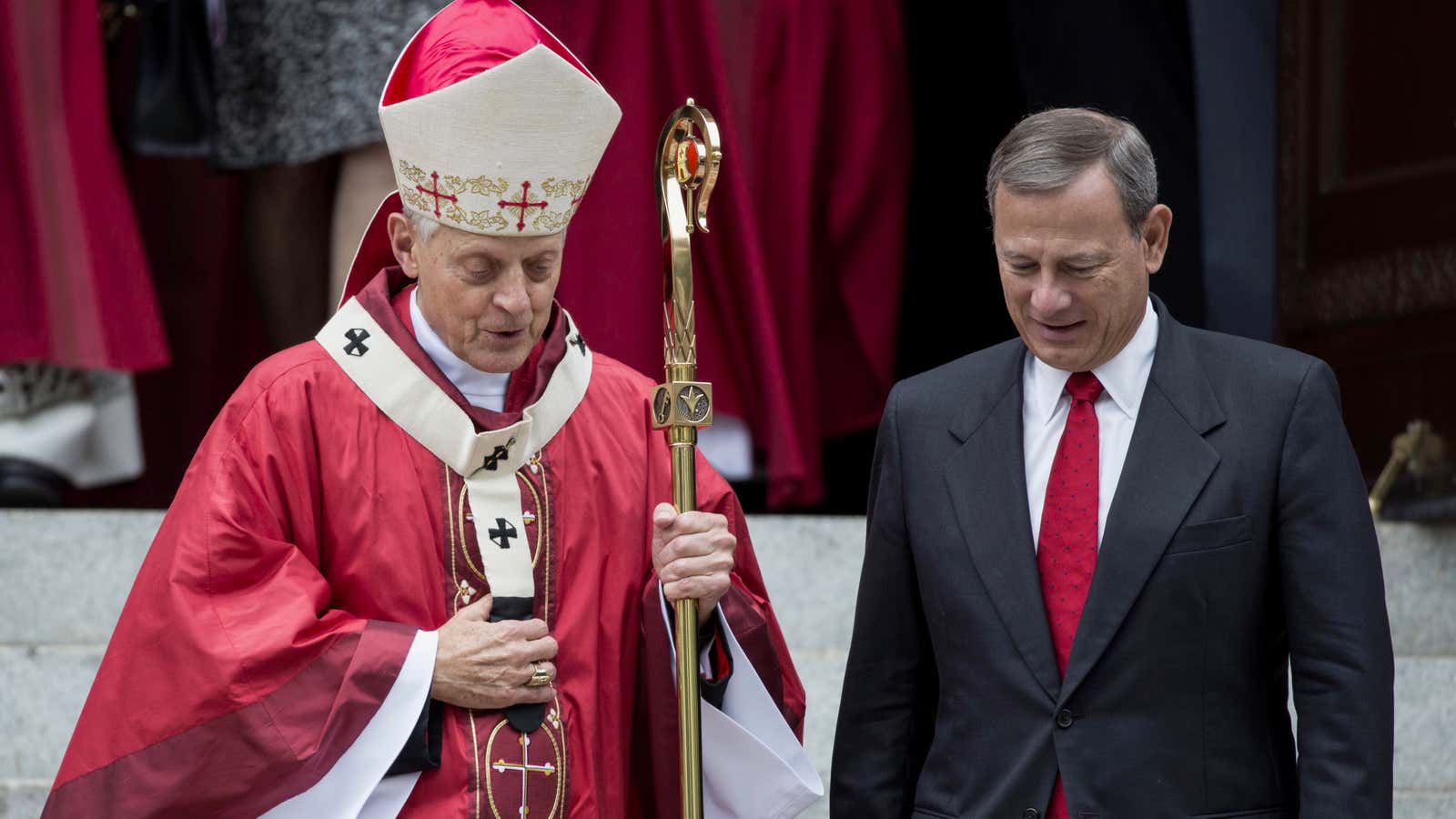 Supreme Court Chief Justice John Roberts (R) speaks with Cardinal Donald Wuerl (L), archbishop of Washington on October 4, 2015.