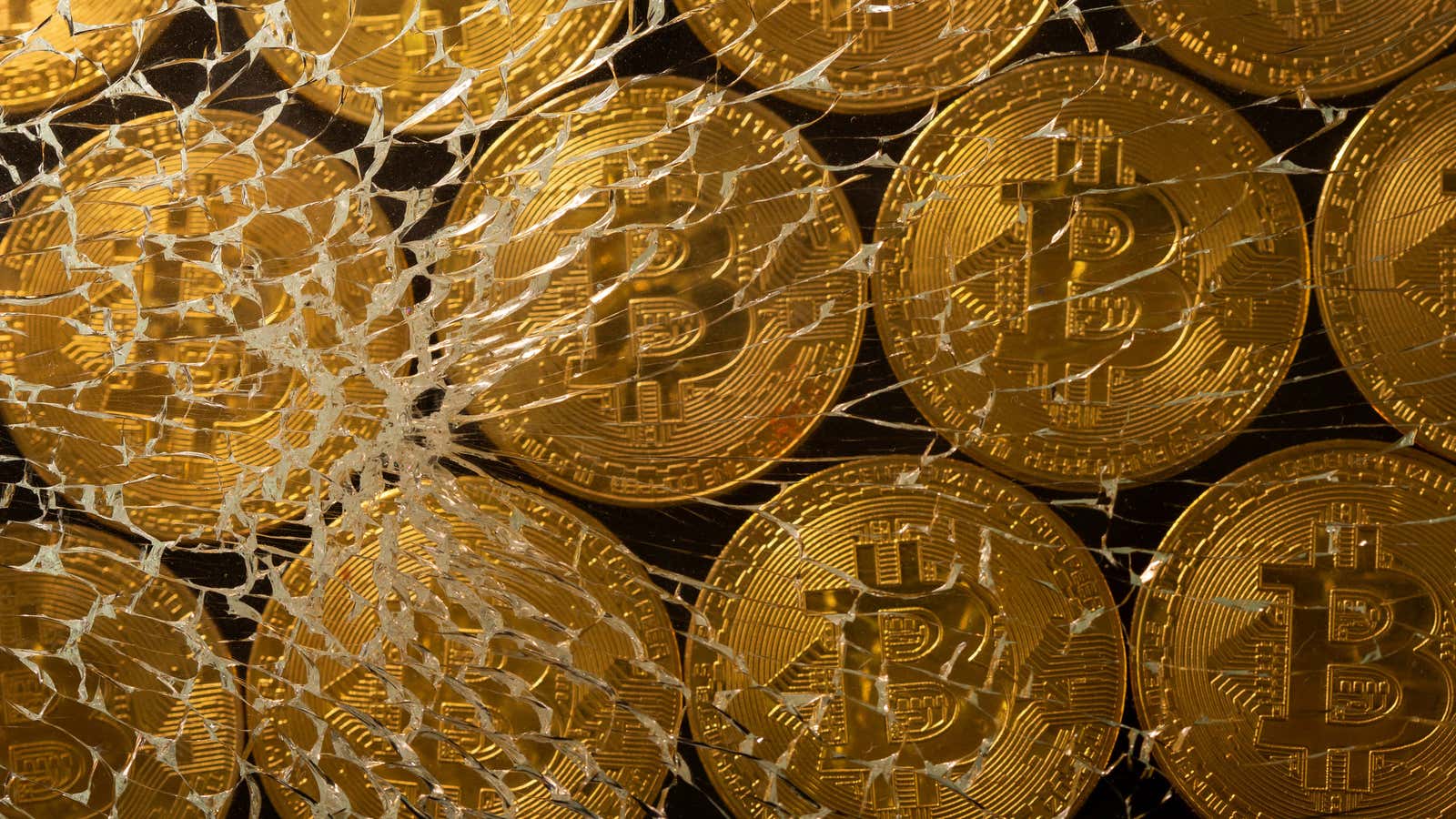 Representations of virtual currency bitcoin are seen through broken glass in this illustration taken, June 25, 2021. REUTERS/Dado Ruvic/Illustration