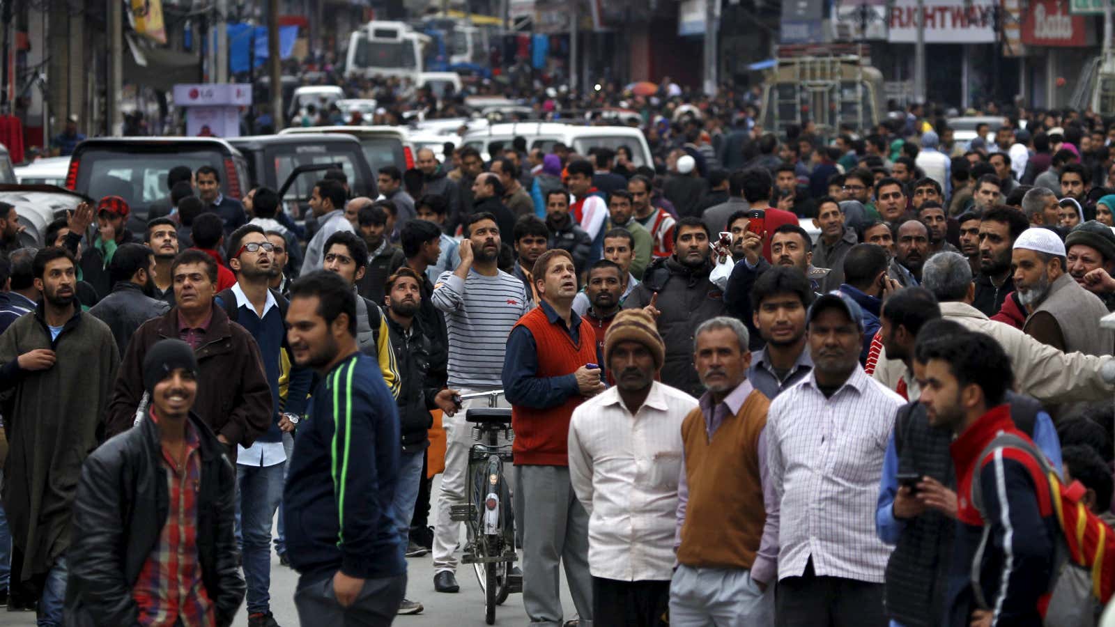 People stand on a road after the earthquake in Srinagar, India.