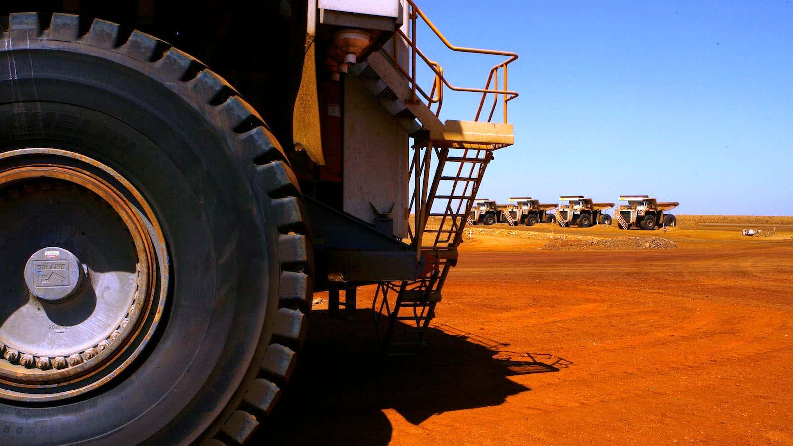 In this photo taken on March 4, 2010, large dump trucks are lined up at Rio Tinto operations at Dampier in Western Australia. Mining giant…