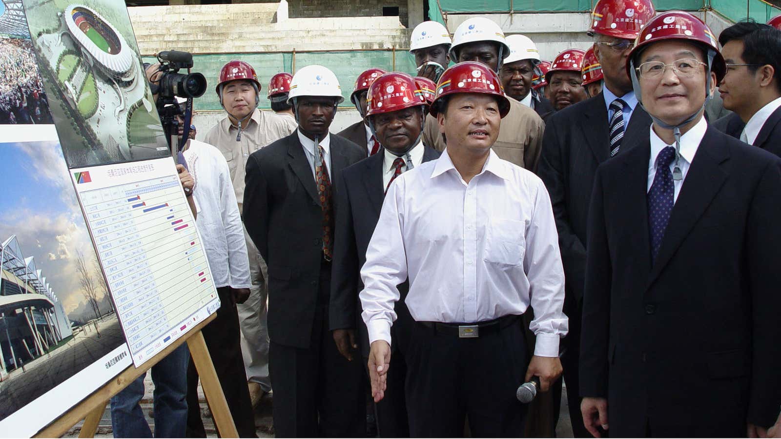 Chinese Premier Wen Jiabao, right, talk to Chinese construction workers who are supervising the building of a sports stadium in Dar Es Salaam, Tanzania Friday,…