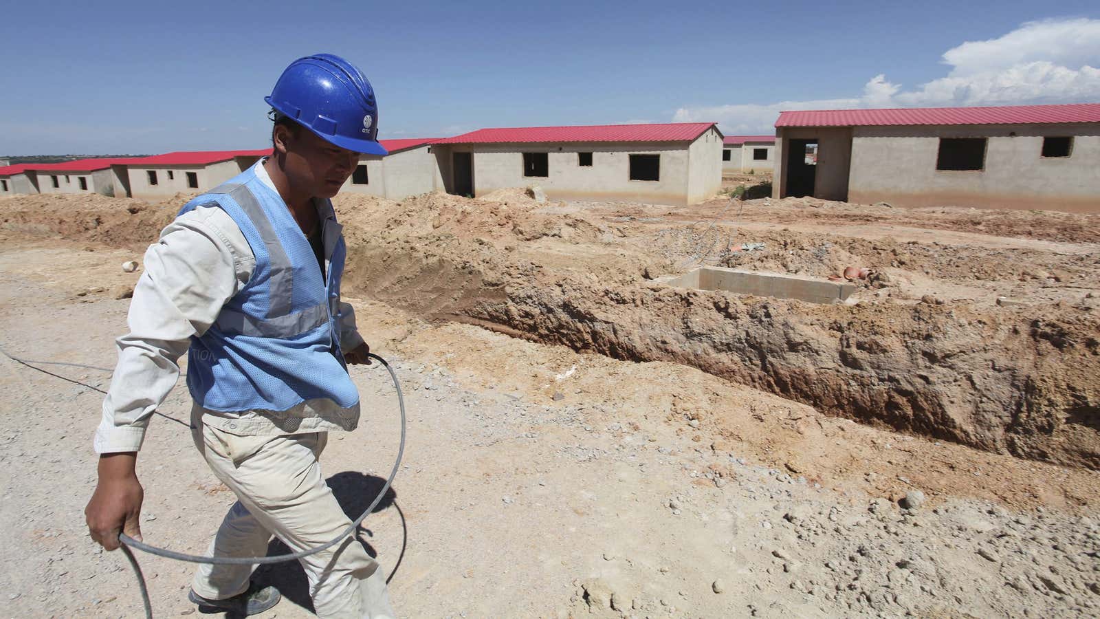 A Chinese worker walks past a construction site in Lubango, Angola (March 2014)