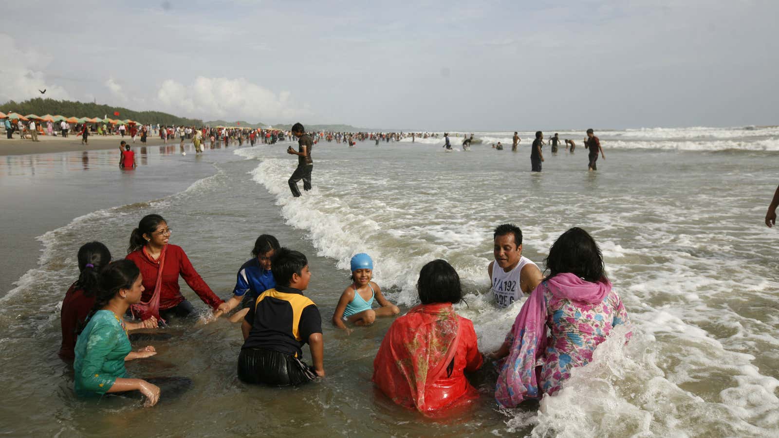 It’s better in Bangladesh. A family enjoys a day at the beach in Cox’s Bazaar.