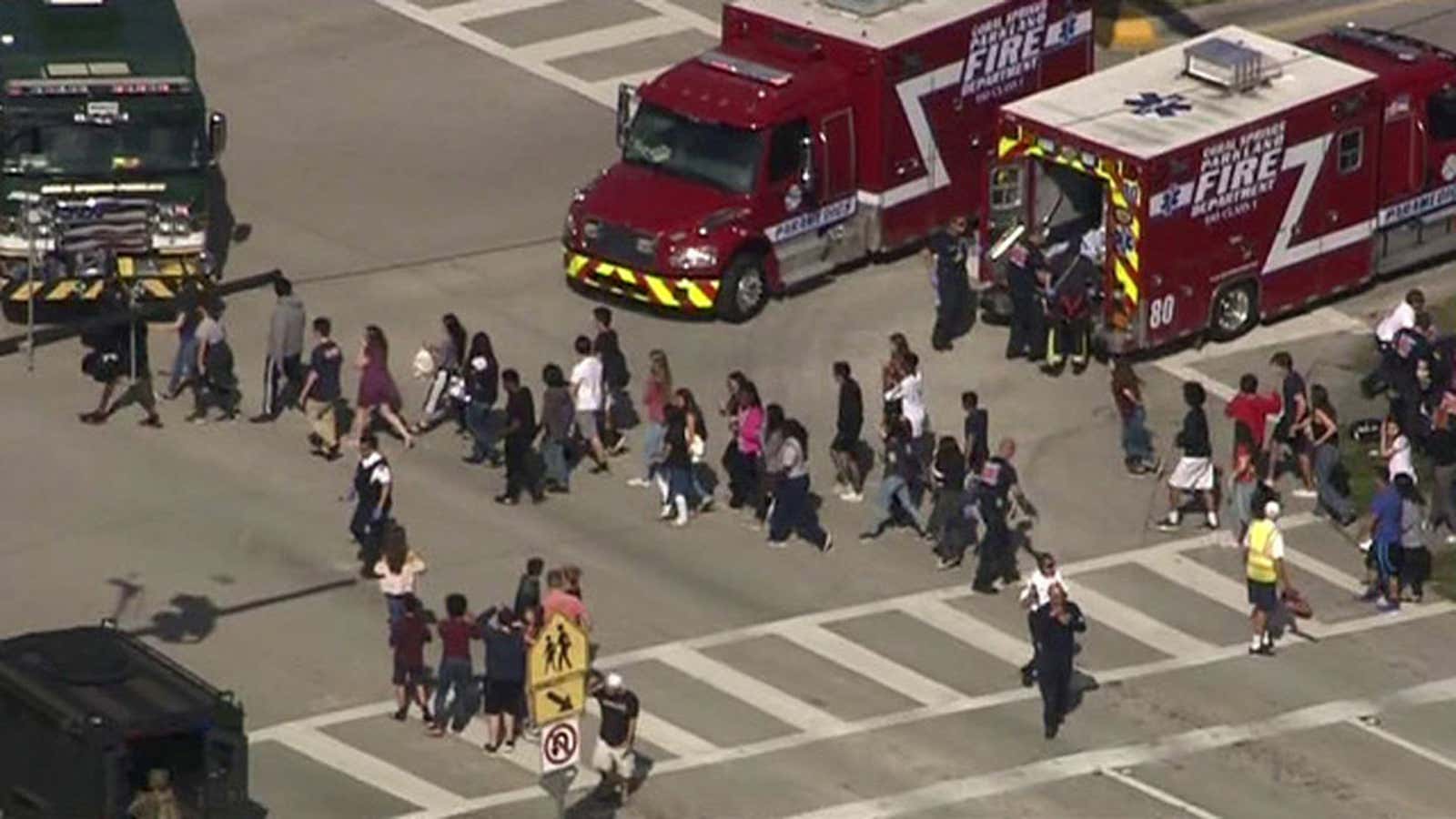 Students are evacuated from Marjory Stoneman Douglas High School during a shooting incident in Parkland, Florida on February 14, 2018 in a still image from video.
