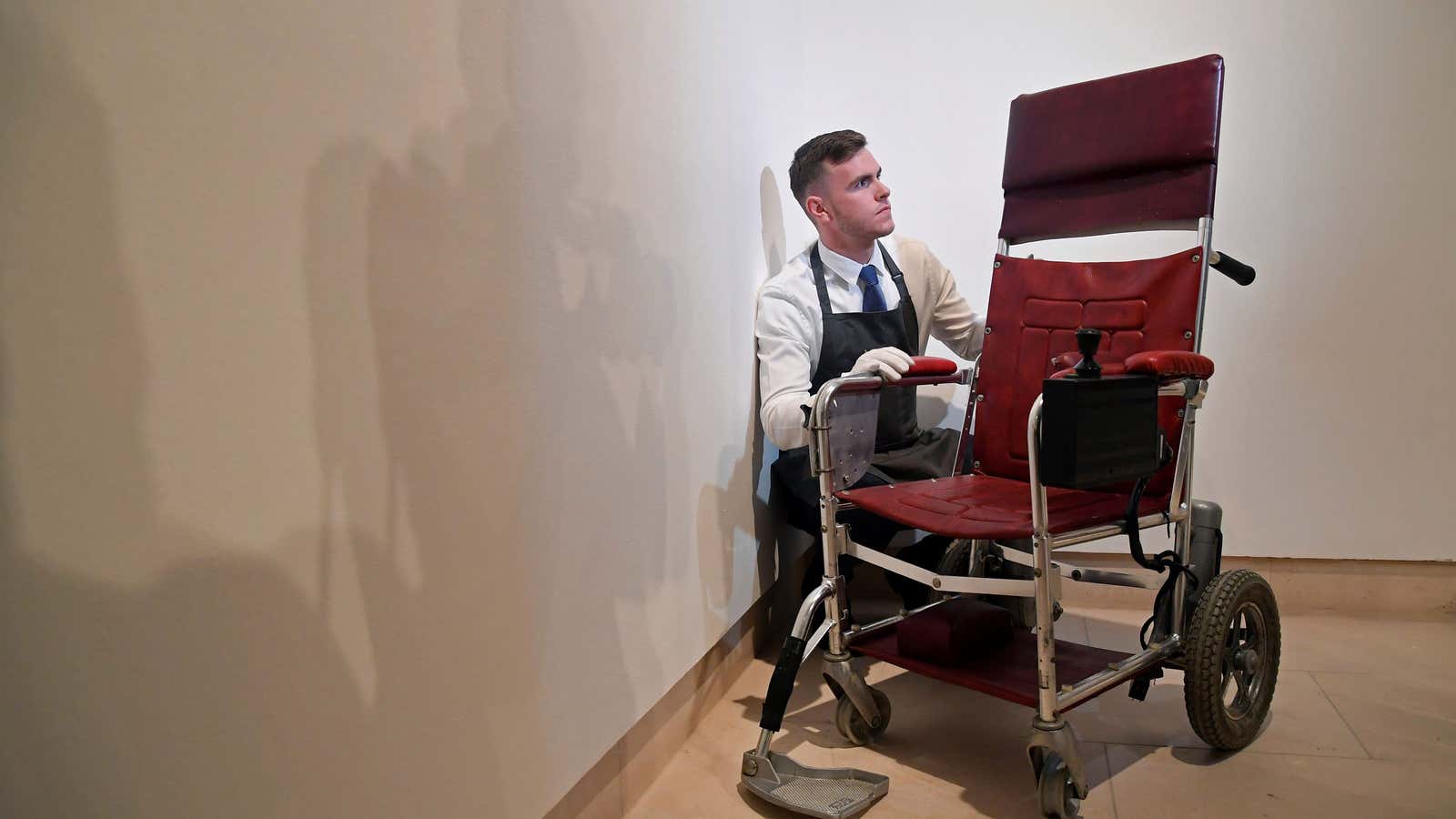 Fine-art handler Tom Richardson with Hawking’s wheelchair prior to auction.