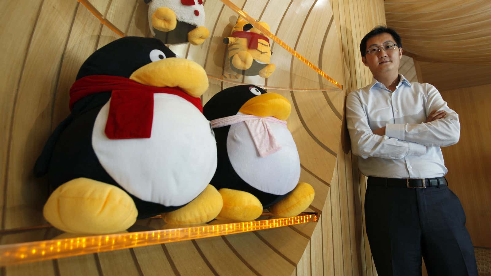 Tencent CEO Pony Ma stands beside mascots for QQ.com, the company’s instant-messaging service.