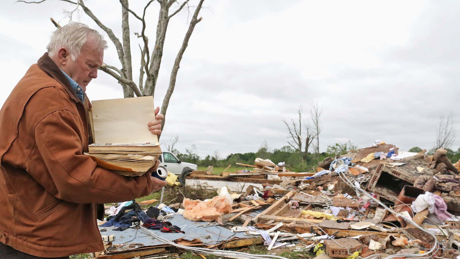 Robert Scott looks through a family Bible that he pulled out of the rubble on April 14, outside of Hamilton, Mississippi.