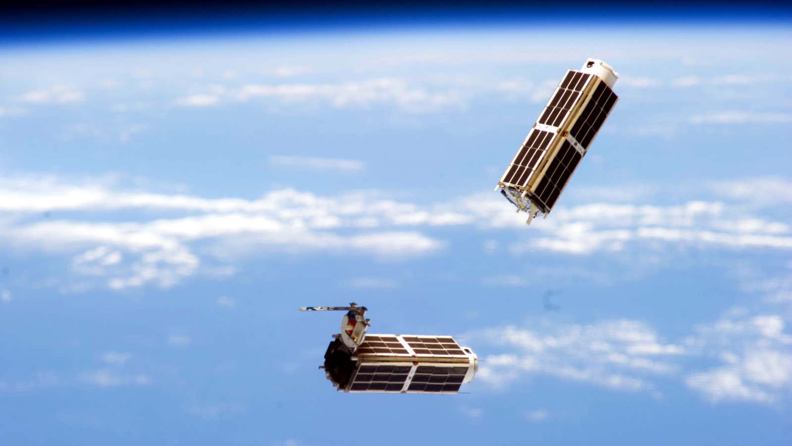 Two of the new generation of small satellites in orbit after being deployed from the International Space Station.