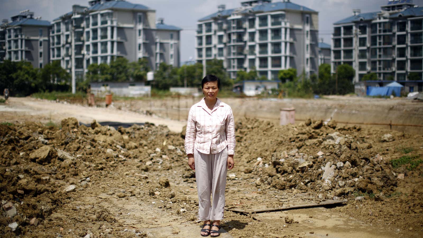 18 kidnappings later, Xu Haifeng poses where her family’s house once stood.