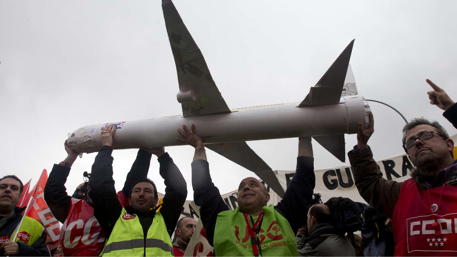 Iberia workers carry a model plane as they protest outside Barajas international airport in Madrid, Spain, Monday Feb. 18, 2013. Protesters clashed with police at…