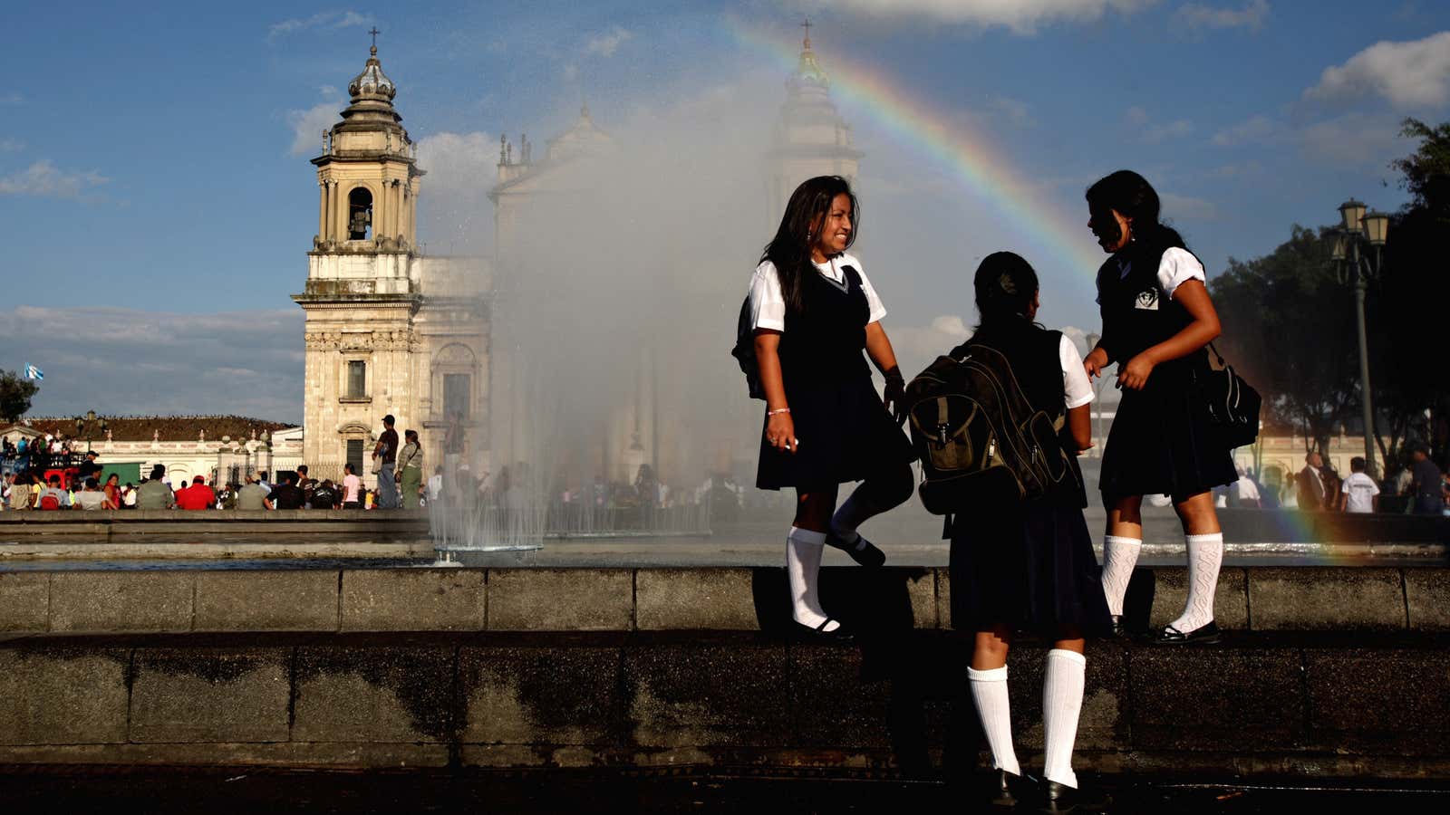 Schoolgirls talk near a fountain at the Parque Central in Guatemala City. In Guatemala, 30% of women are married by the age of 18.