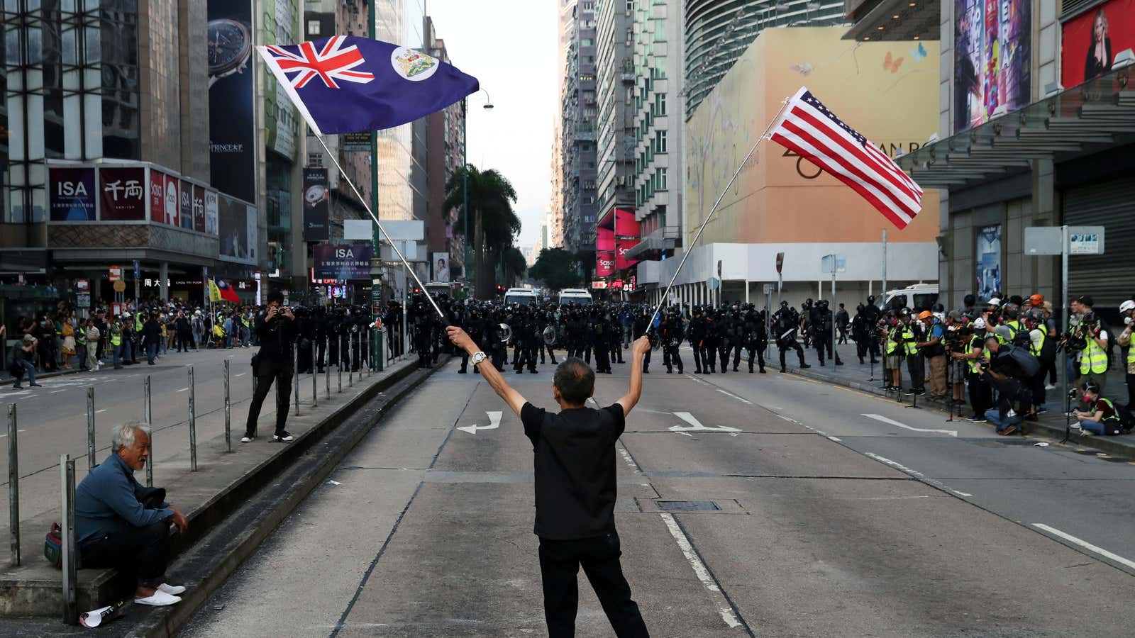 A protester waves a U.S. and a colonial Hong Kong flags during the “Lest We Forget” rally in Hong Kong, China December 1, 2019. REUTERS/Leah…