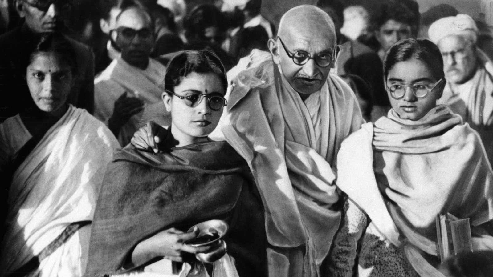 Mahatma Gandhi with two of his disciples.