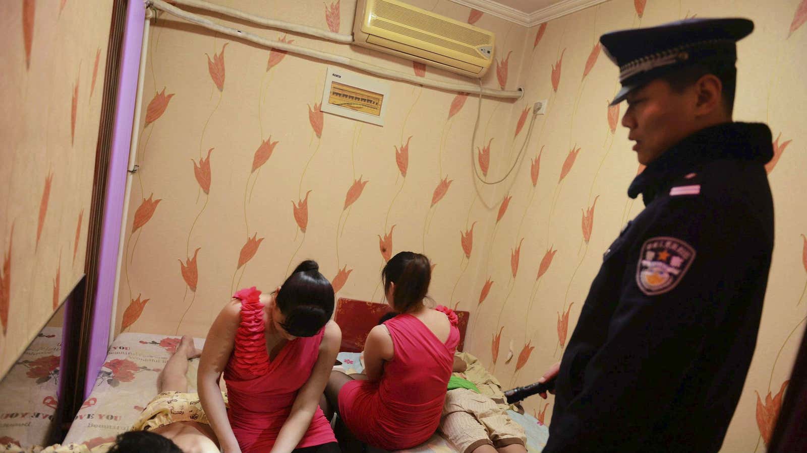 Police inspect a massage parlor in Shandong province.