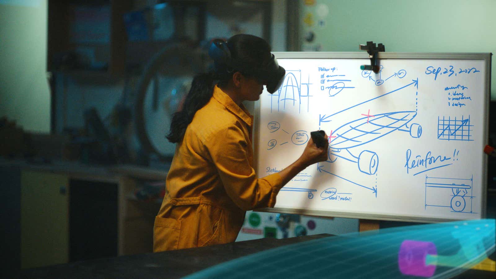 A person using the Meta Quest Pro&#39;s passthrough feature to work on a whiteboard diagram. 