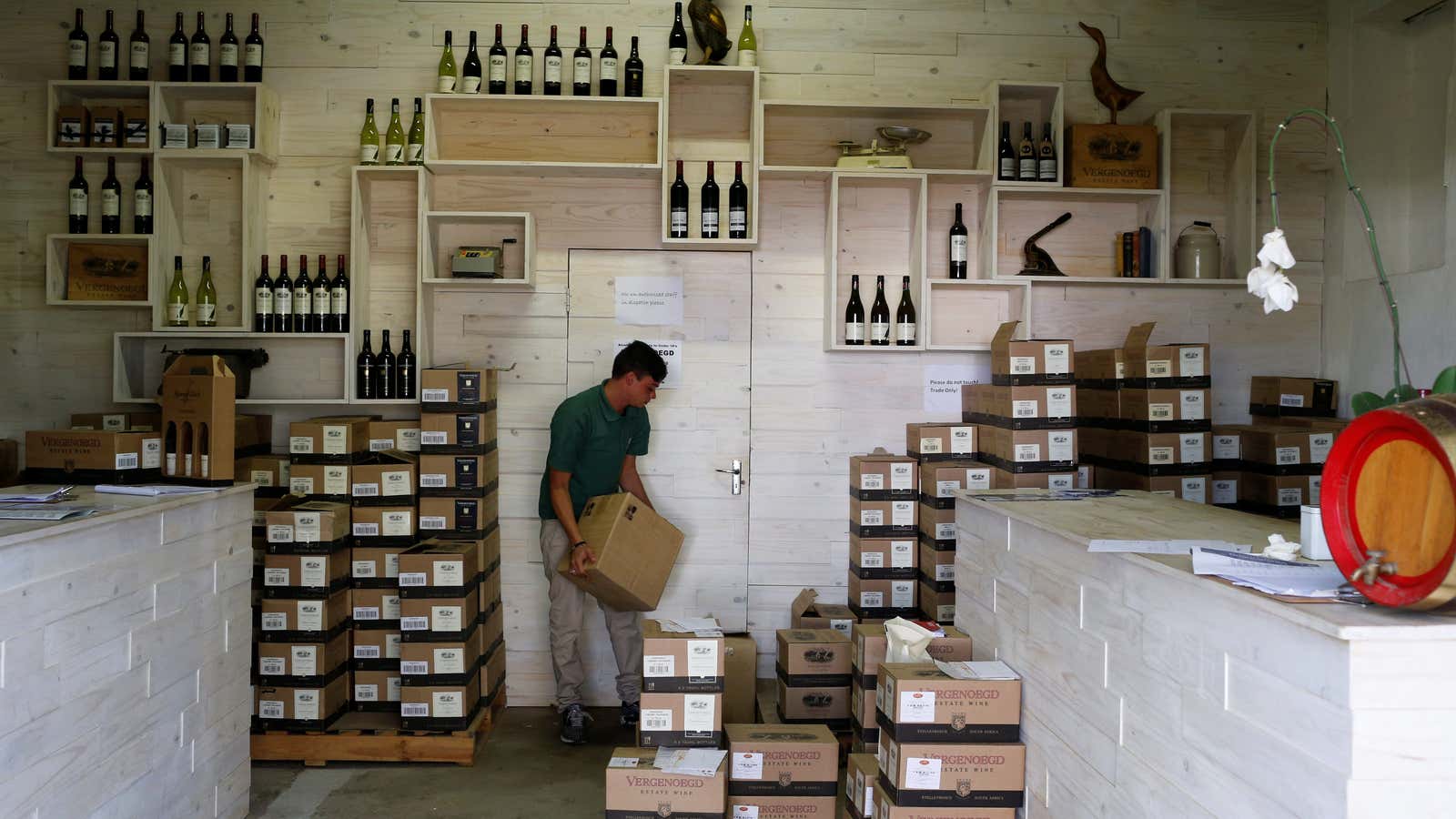 A farmworker stacks boxes of wine for sale at the Vergenoegd wine estate near Cape Town.