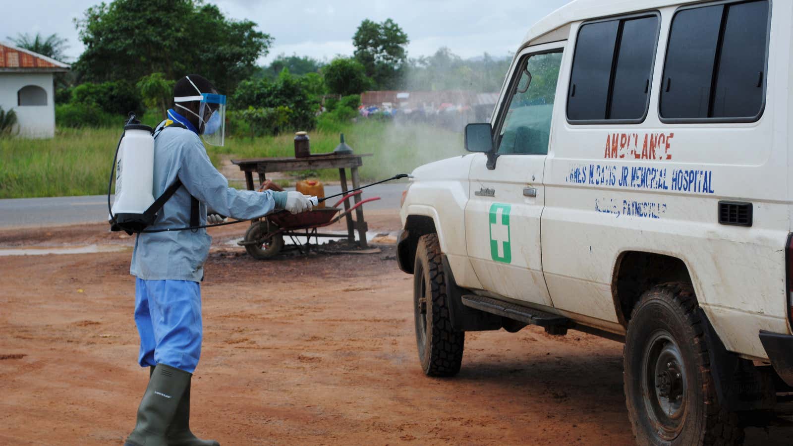 A health worker sprays disinfectant on an ambulance in Nedowein, Liberia in July, 2015.