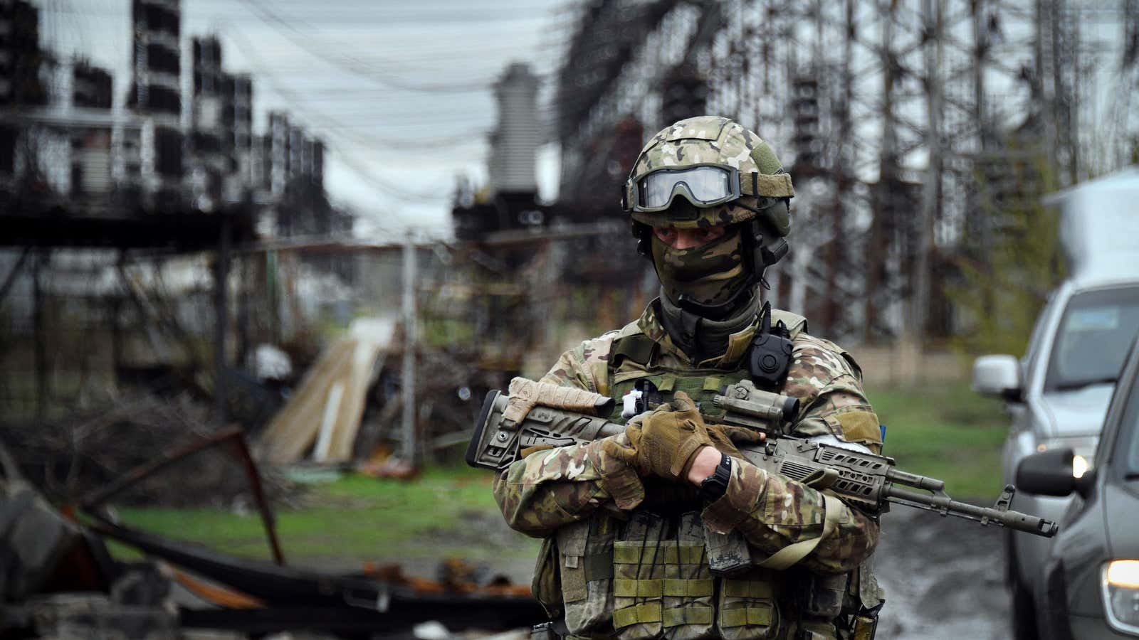 In this picture taken on April 13, 2022, a Russian soldier stands guard at the Luhansk power plant in the town of Shchastya. (Photo by Alexander NEMENOV / AFP) (Photo by ALEXANDER NEMENOV/AFP via Getty Images)