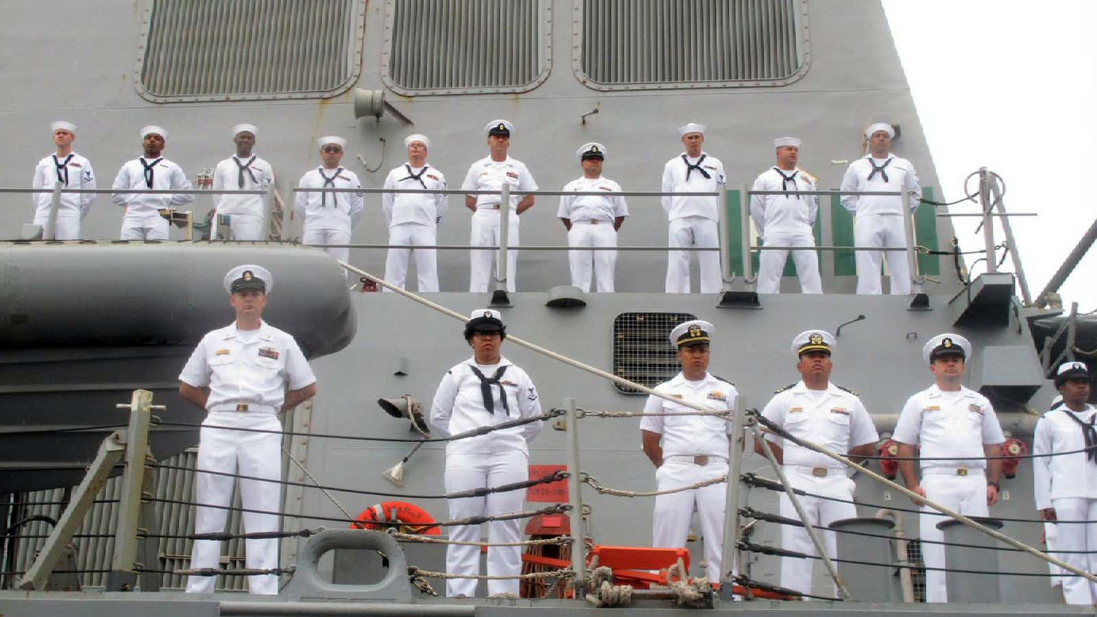 U.S. Navy sailors stand on deck as the guided missile destroyer USS Benfold arrives in port in Qingdao in eastern China’s Shandong Province.