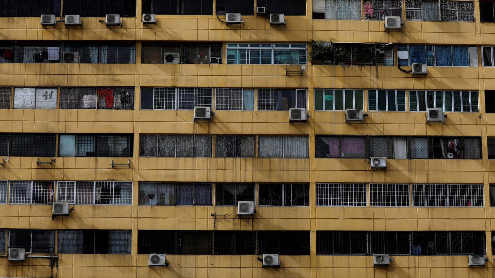Air-conditioning units dot the facade of People’s Park Complex condominium in Singapore, January 5, 2021.