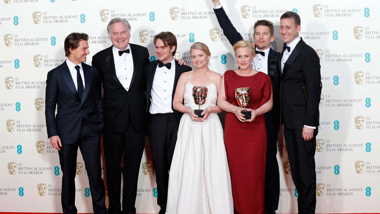 Presenter Tom Cruise (L) celebrates with (2nd L-R) Jonathan Sehring, Ellar Coltrane, Cathleen Sutherland, Patricia Arquette Ethan Hawke, and John Sloss after they won the…