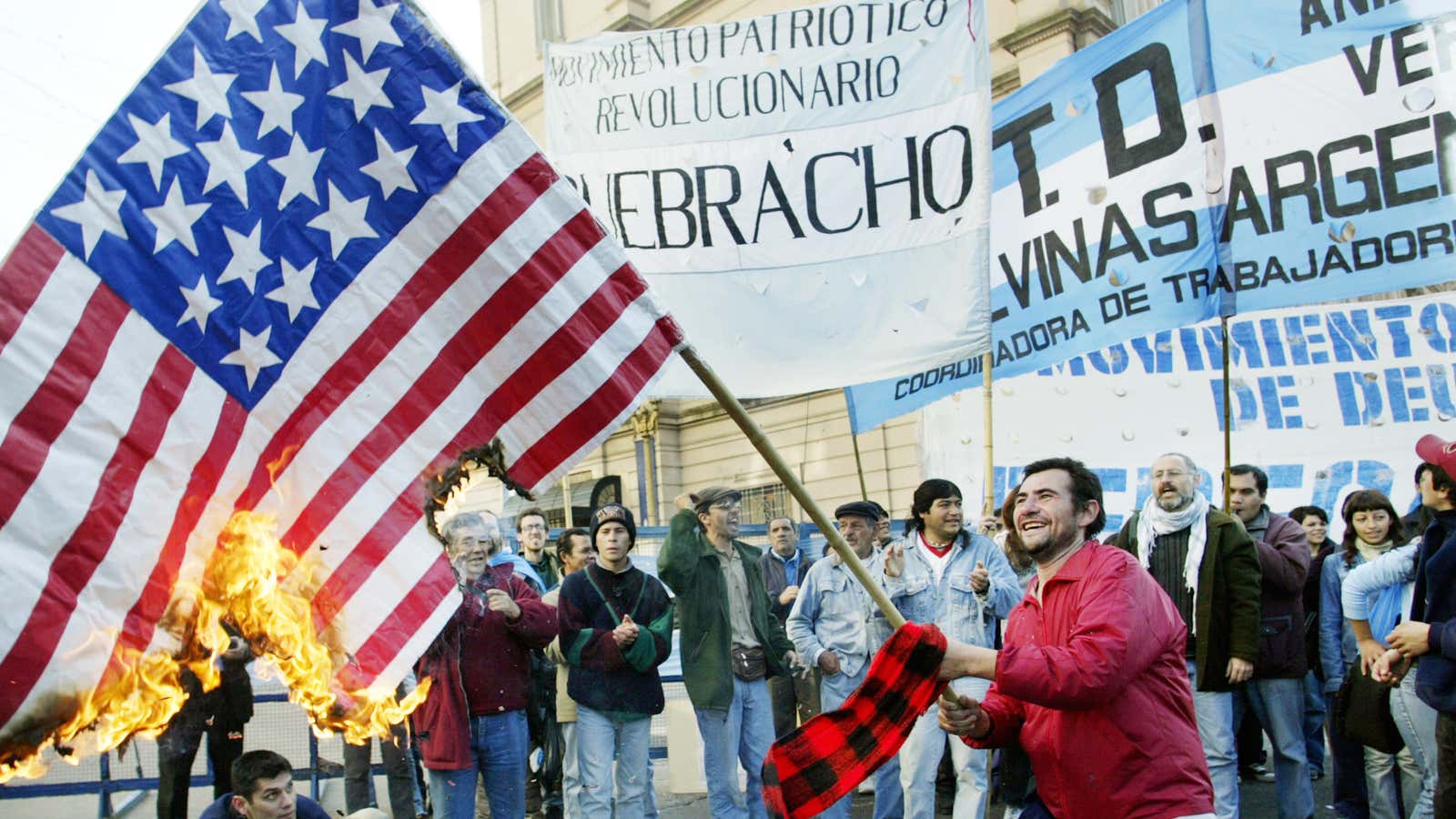 Argentine activists burn a United States flag  in the midst of the country’s economic debt
crisis.