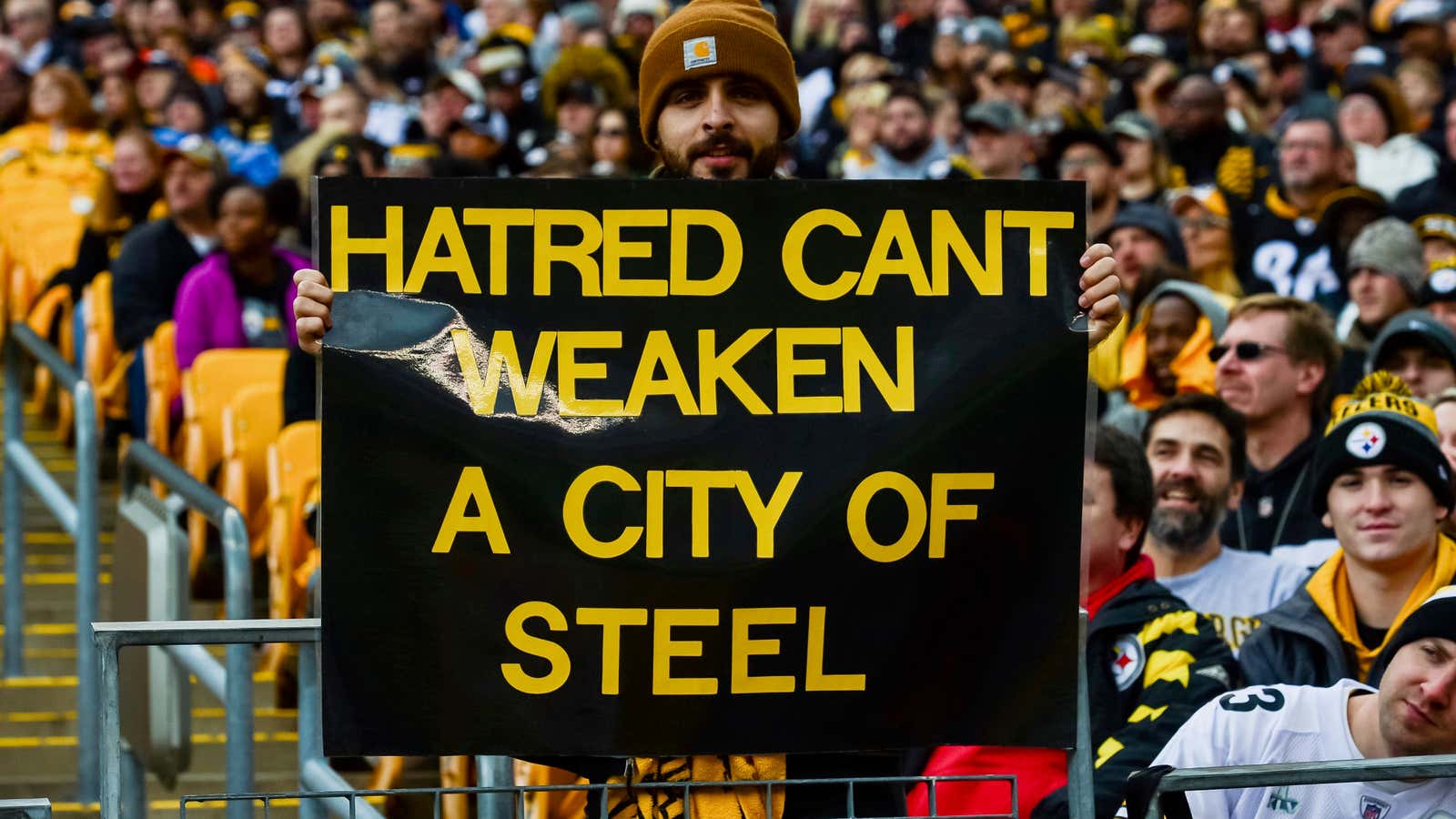 Posters honor the victims of the shooting at the Tree of Life Synagogue at a Pittsburgh Steelers game.