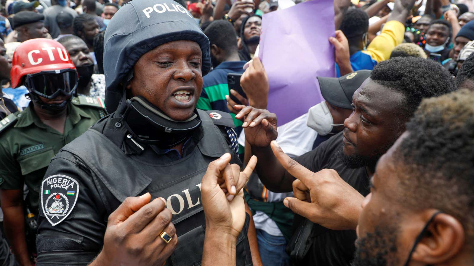 Demonstrators talk to a police officer in Lagos, Nigeria Oct. 12.