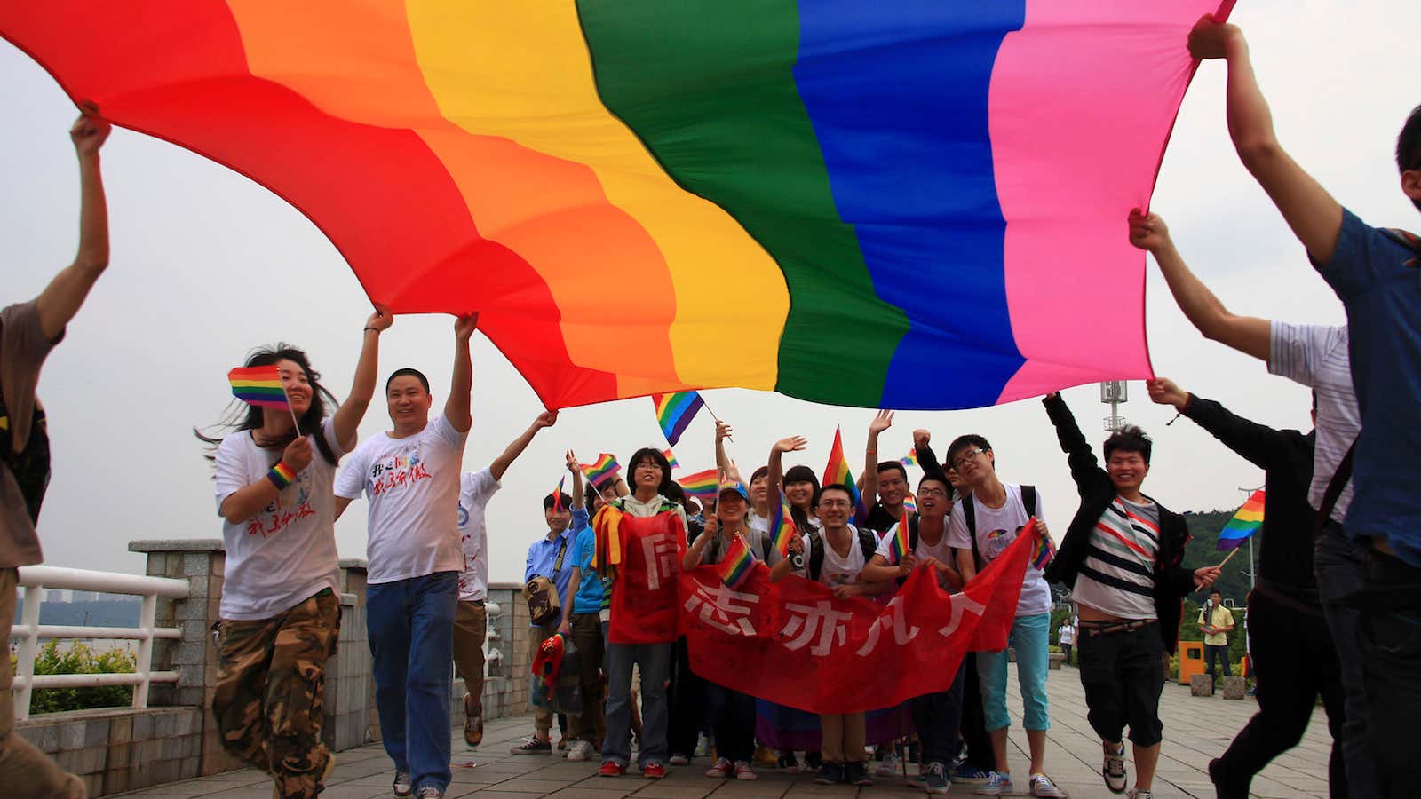 Gay-rights activists in the Hunan province hold a banner that reads “Homosexsuals are also ordinary people”.