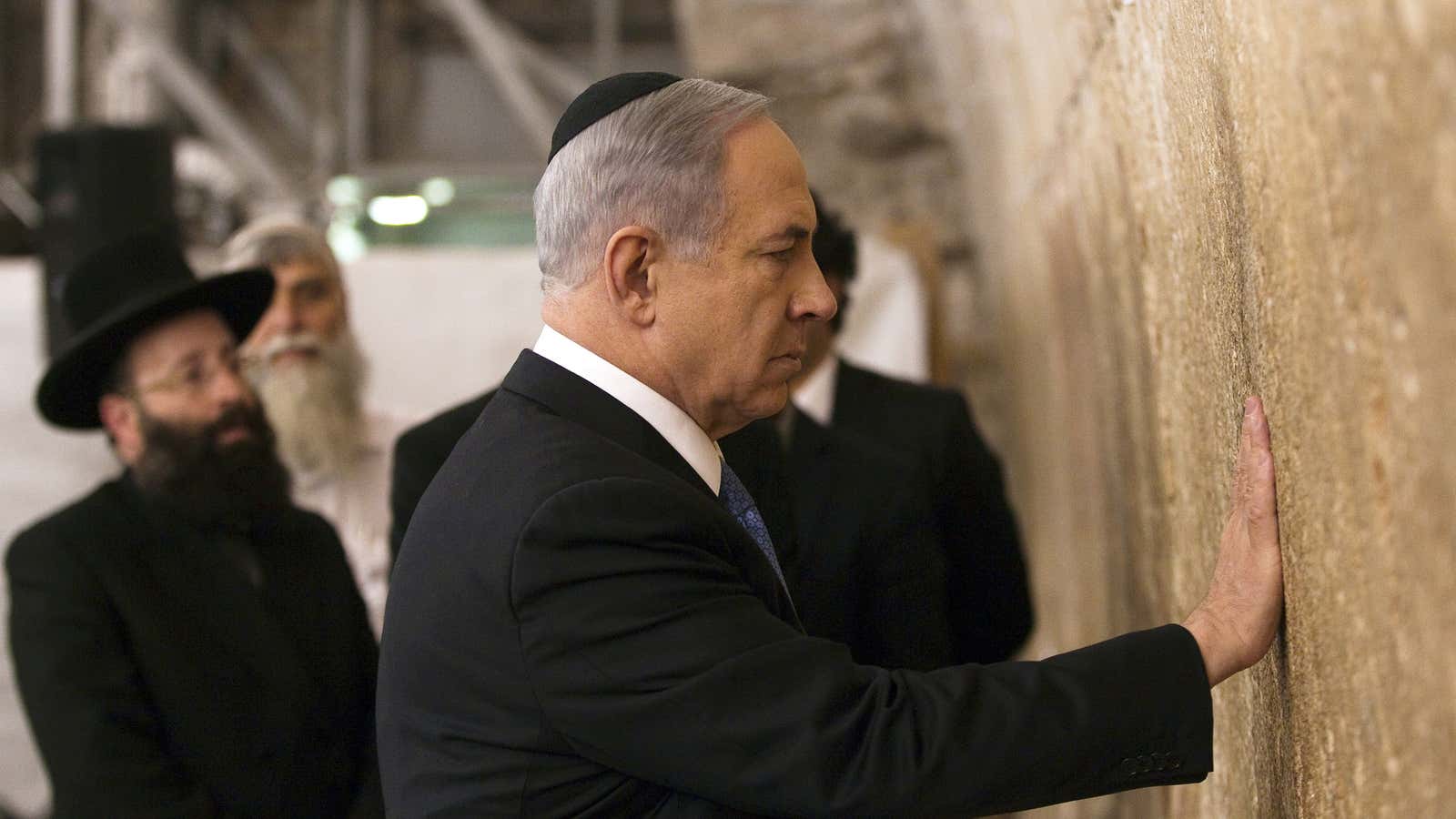 Israel’s Prime Minister Benjamin Netanyahu touches the stones of the Western Wall, Judaism’s holiest prayer site, in Jerusalem’s Old City a day after winning Israel’s election for prime minister.